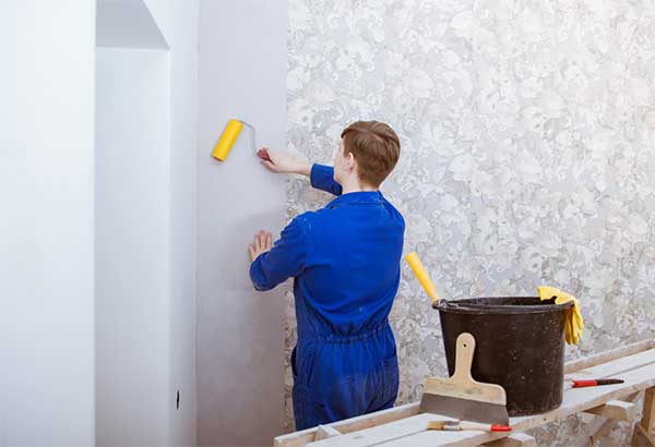 Image of a worker installing wallpaper